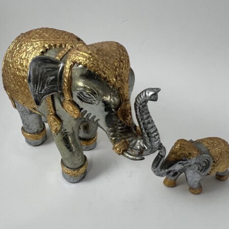 Authentic Thai elephant figurine purchased in Bangkok in 1995, featuring hand-applied gold leaf and traditional craftsmanship. A unique, culturally significant decorative piece. 