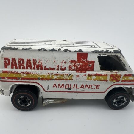 white paramedic ambulance diecast van with red cross graphics side view right profile worn condition