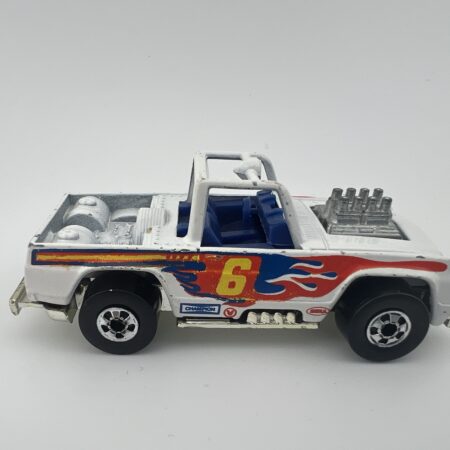 Vintage 1973 Hot Wheels Baja Bruiser pickup Champion white blackwall diecast number 6 with flame decals right side view