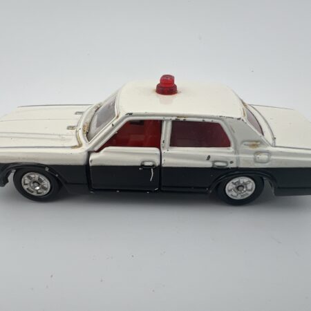 black and white police diecast car with red light bar side view right profile