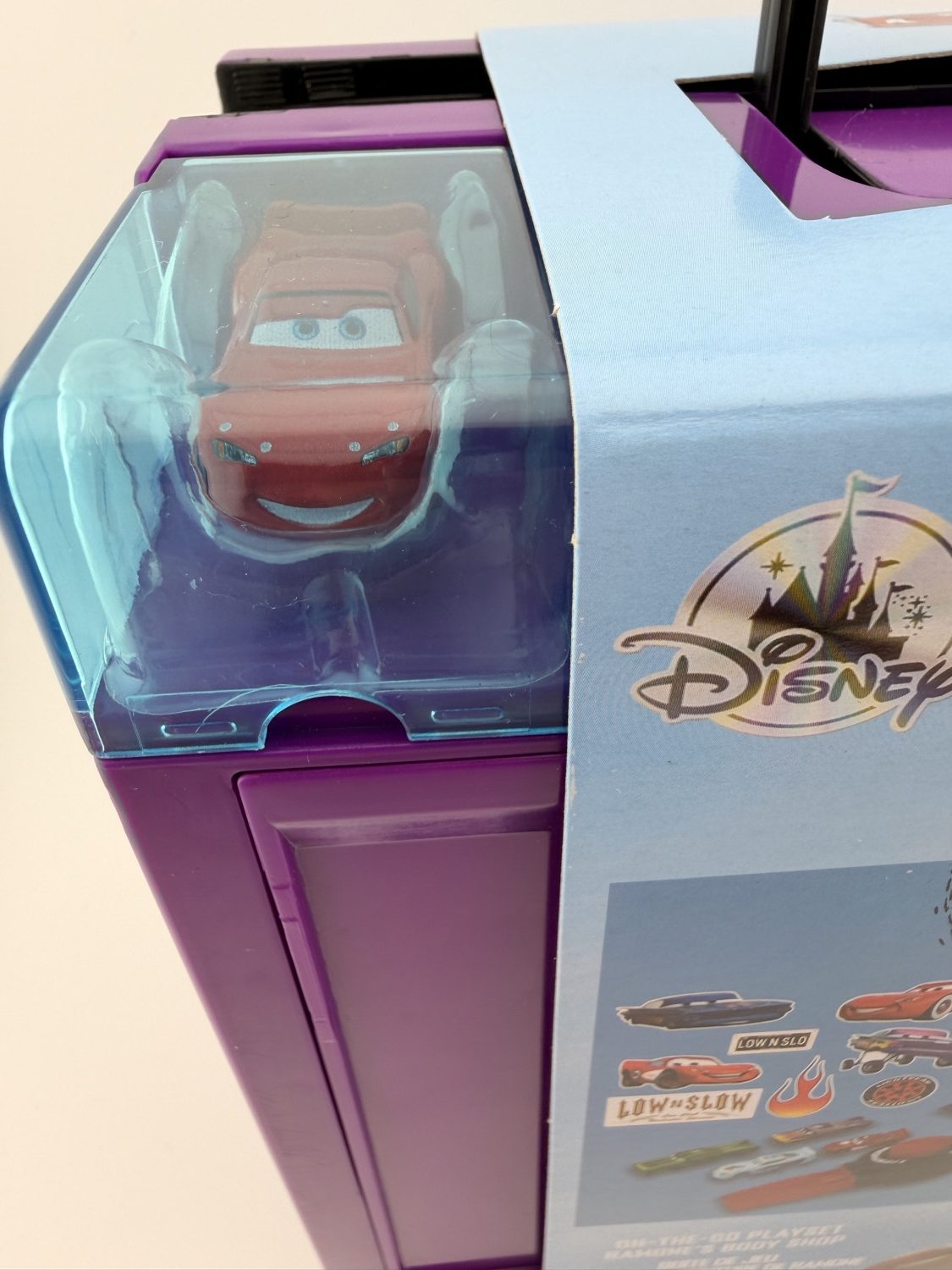Lightning McQueen diecast car inside Disney Cars playset case window